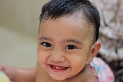 Portrait of cute baby girl smiling with taking bath