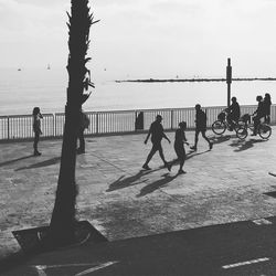 People on beach against sky