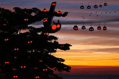 Low angle view of silhouette trees against sky at sunset