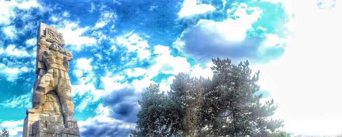 Low angle view of building against cloudy sky