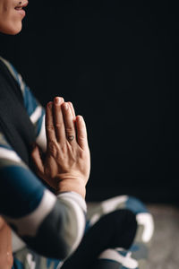 Cropped image of people hands against black background