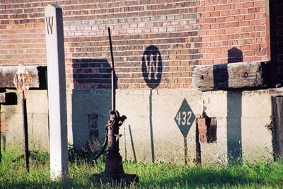 Statue against brick wall