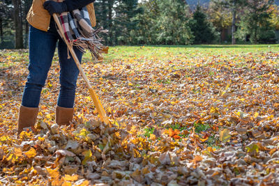 Low section of person standing on field during autumn