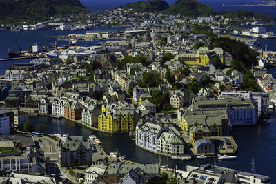 High angle view of cityscape by river against sky