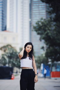 Portrait of woman standing in city