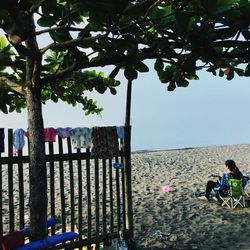 People at beach against sky