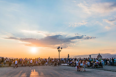 People watching florence panorama during summer sunset from piazzale michelangelo florence, italy