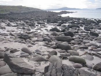 Rocks on beach against sky
