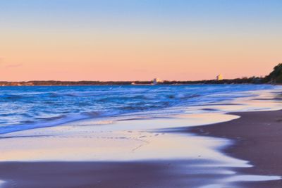 Scenic view of sea against clear sky during sunset