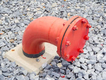 High angle view of red fire hydrant on cobblestone street