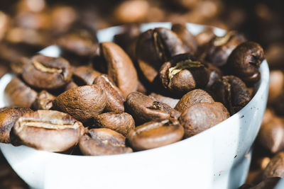 Close-up of roasted coffee beans in jar