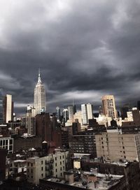 View of cityscape against cloudy sky