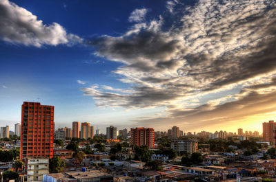 View of cityscape against cloudy sky