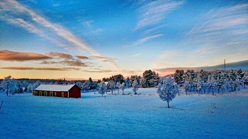 Scenic view of snow covered landscape at dusk