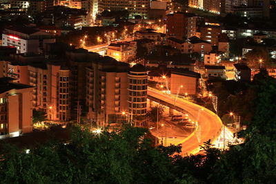 High angle view of illuminated city buildings at night