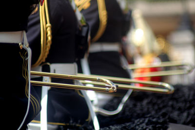 Midsection of musicians playing equipment