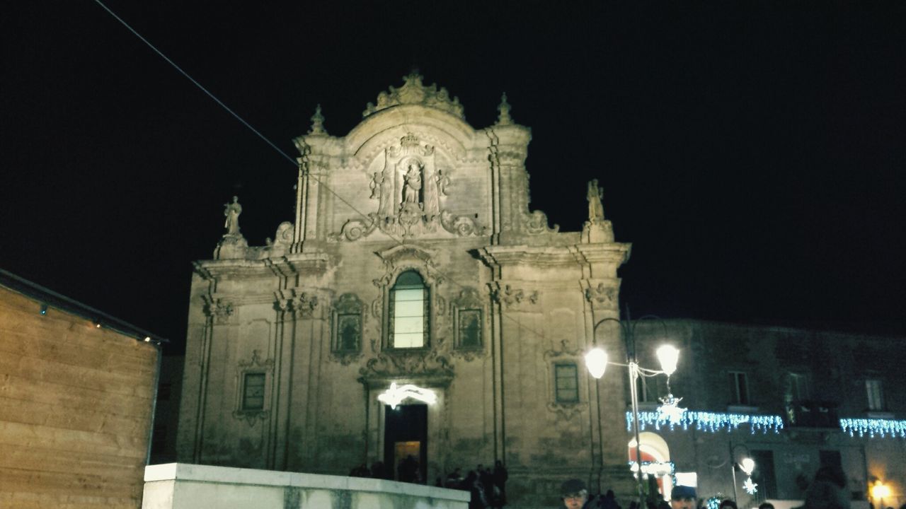 building exterior, architecture, religion, built structure, night, place of worship, church, spirituality, low angle view, illuminated, cathedral, clear sky, history, sky, famous place, travel destinations, cross, steeple