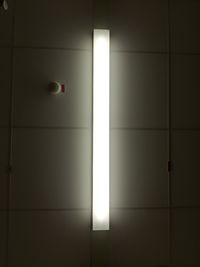 Illuminated light bulbs hanging on wall