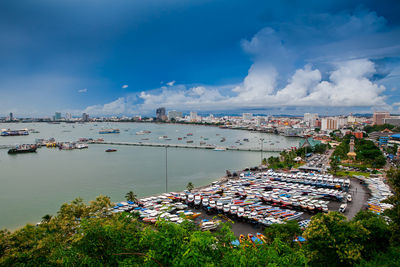 High angle view of harbor by city against sky