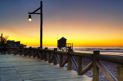 Scenic view of sea against clear sky at sunset