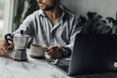 Woman using laptop at home