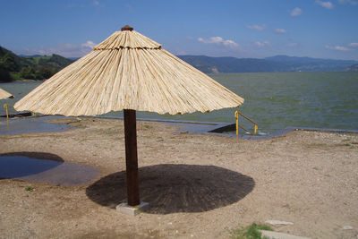 Gazebo on beach against sky