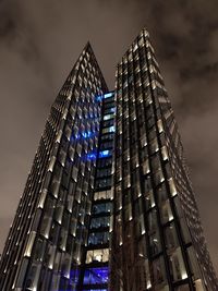 Low angle view of modern buildings against sky at night