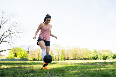 Full length of woman running on field