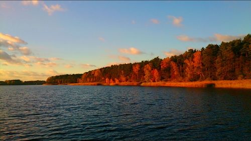 Scenic view of lake against sky at sunset