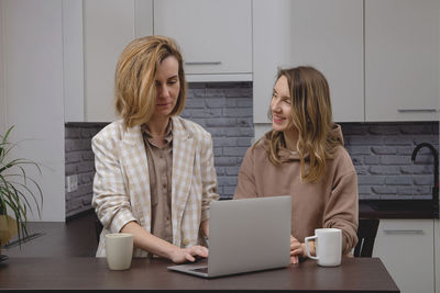 Young woman using laptop at home