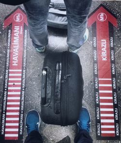 Low section of man standing on tiled floor