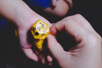 Close-up of person holding yellow ring