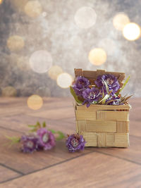 Close-up of purple flower in basket on table