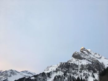 Scenic view of snowcapped mountains against clear sky