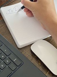 High angle view of man using smart phone on table