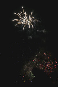 Low angle view of firework display at night