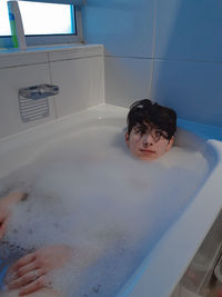 Portrait of boy in bathroom at home