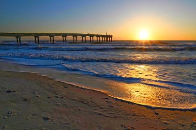 Scenic view of beach against sky during sunset