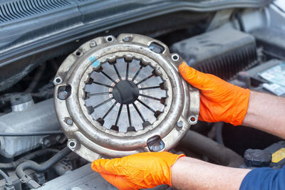 Close-up of man working in car