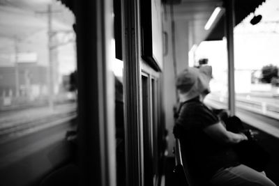 Man looking through train window