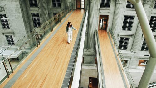 High angle view of person walking on staircase of building