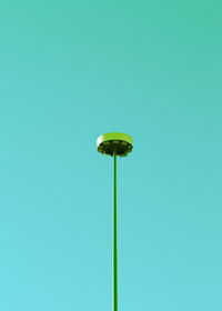 Low angle view of green floodlight against colored background