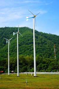 Windmill on field against sky