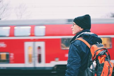 Man standing at railroad station platform