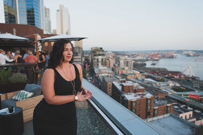 Young woman looking at city buildings