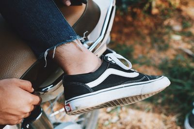 Low section of man holding shoes