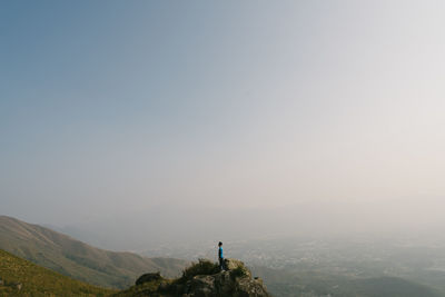 People on landscape against sky