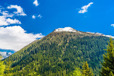 Scenic view of mountain against blue sky