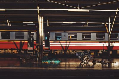 Train at railroad station platform at night