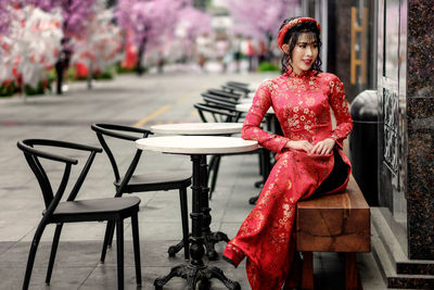 Woman sitting at sidewalk cafe